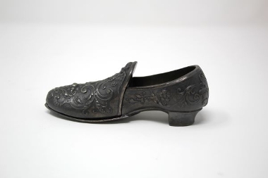 This decorative boot was carved from shale. The carving of shale into jewellery and other items was once a popular past-time.
